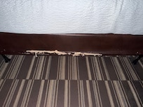 Ripped upholstery on bed
