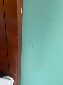 Dirty wall next to bed