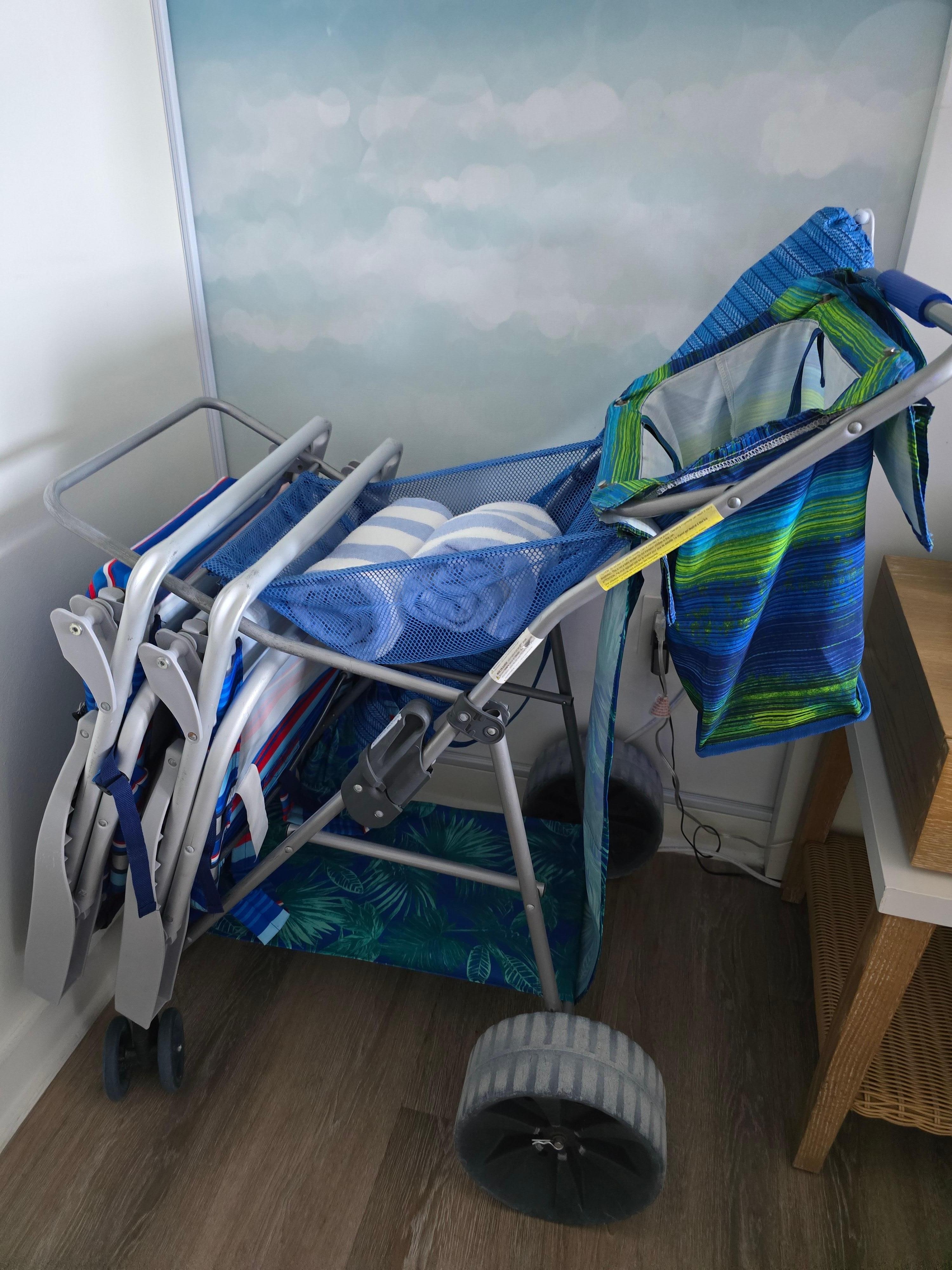 Beach cart with towels and chairs in room that you can use to take to the beach ⛱️ 😀 