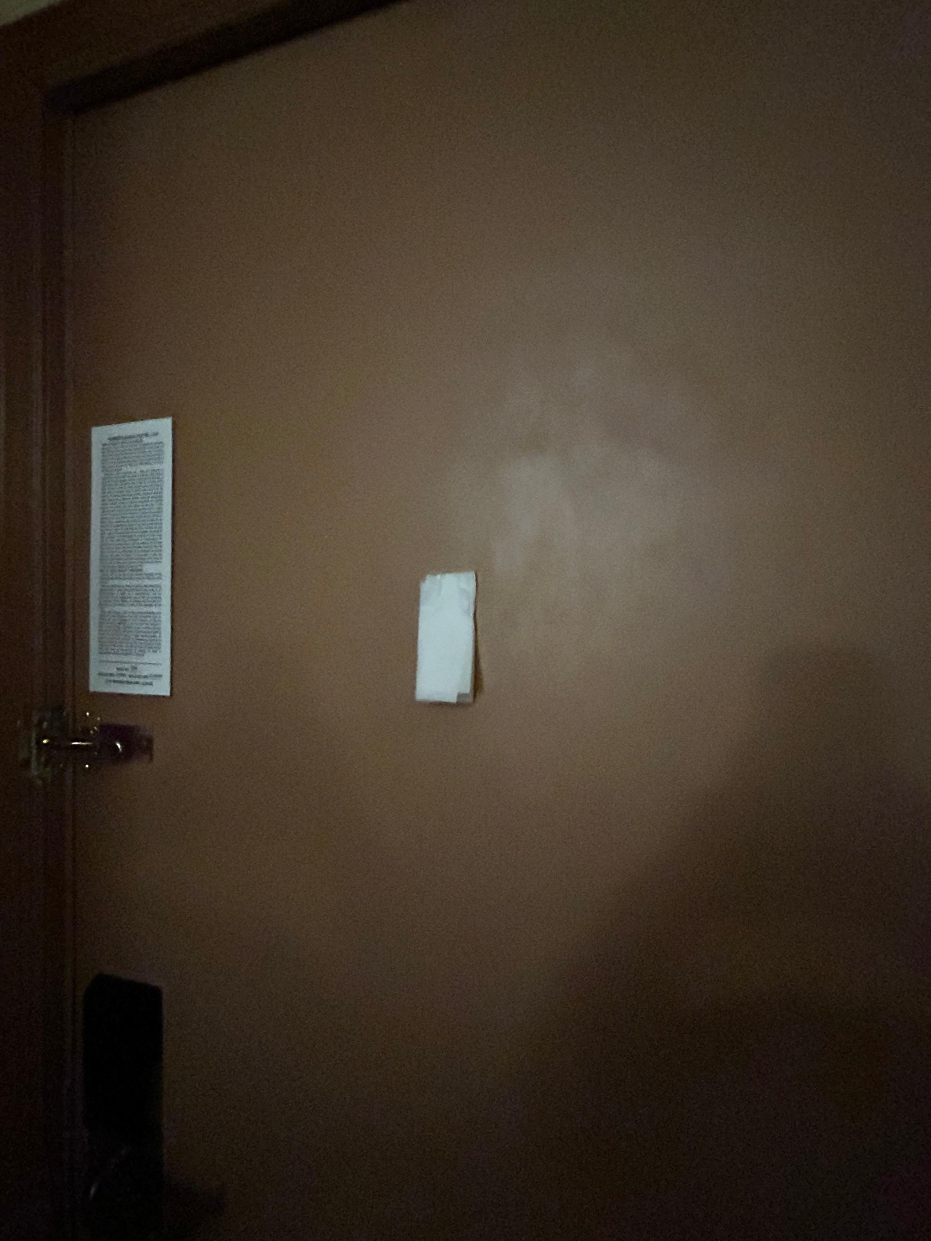 Peephole covered by toilet paper