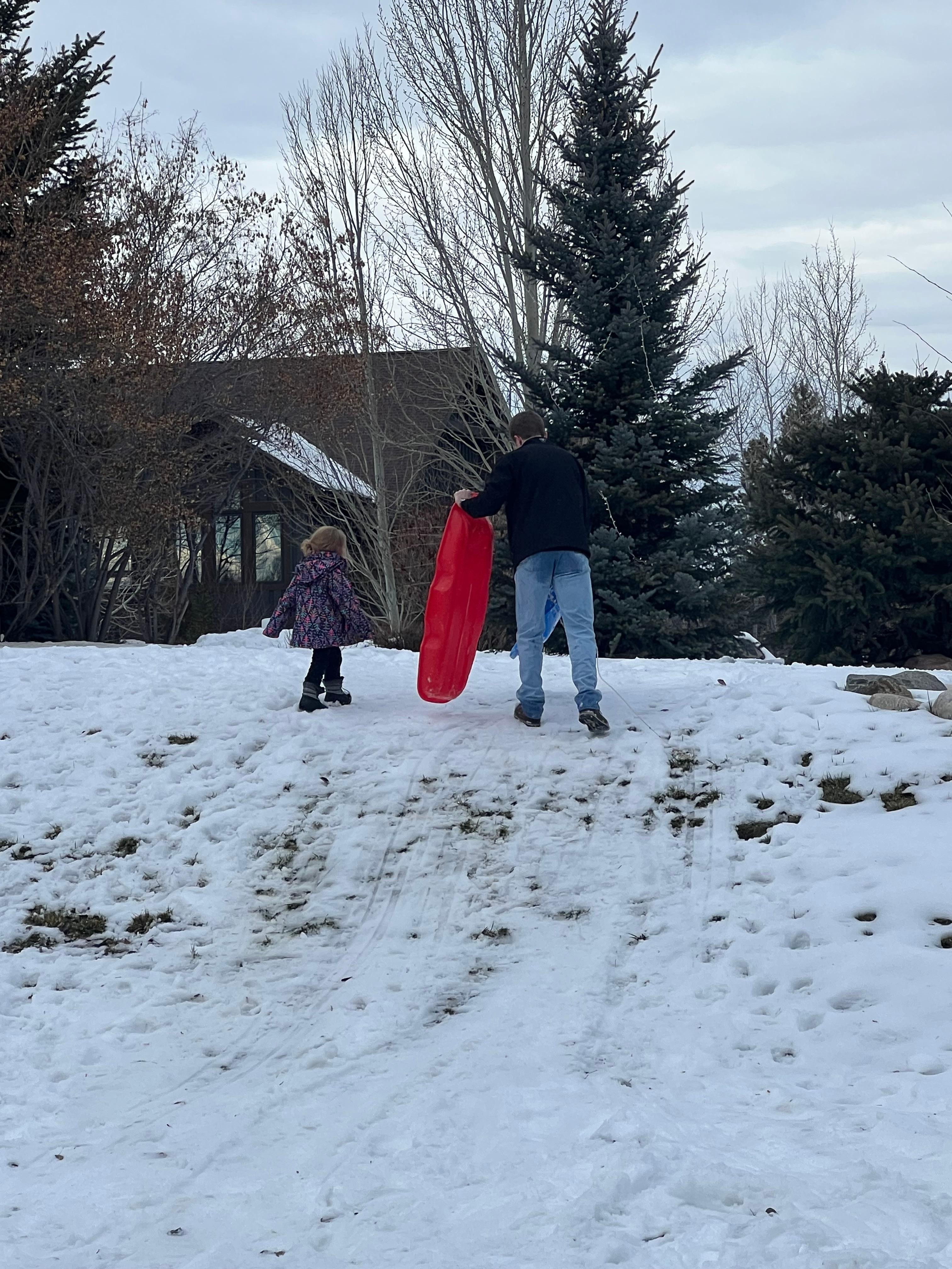Sledding in front of house