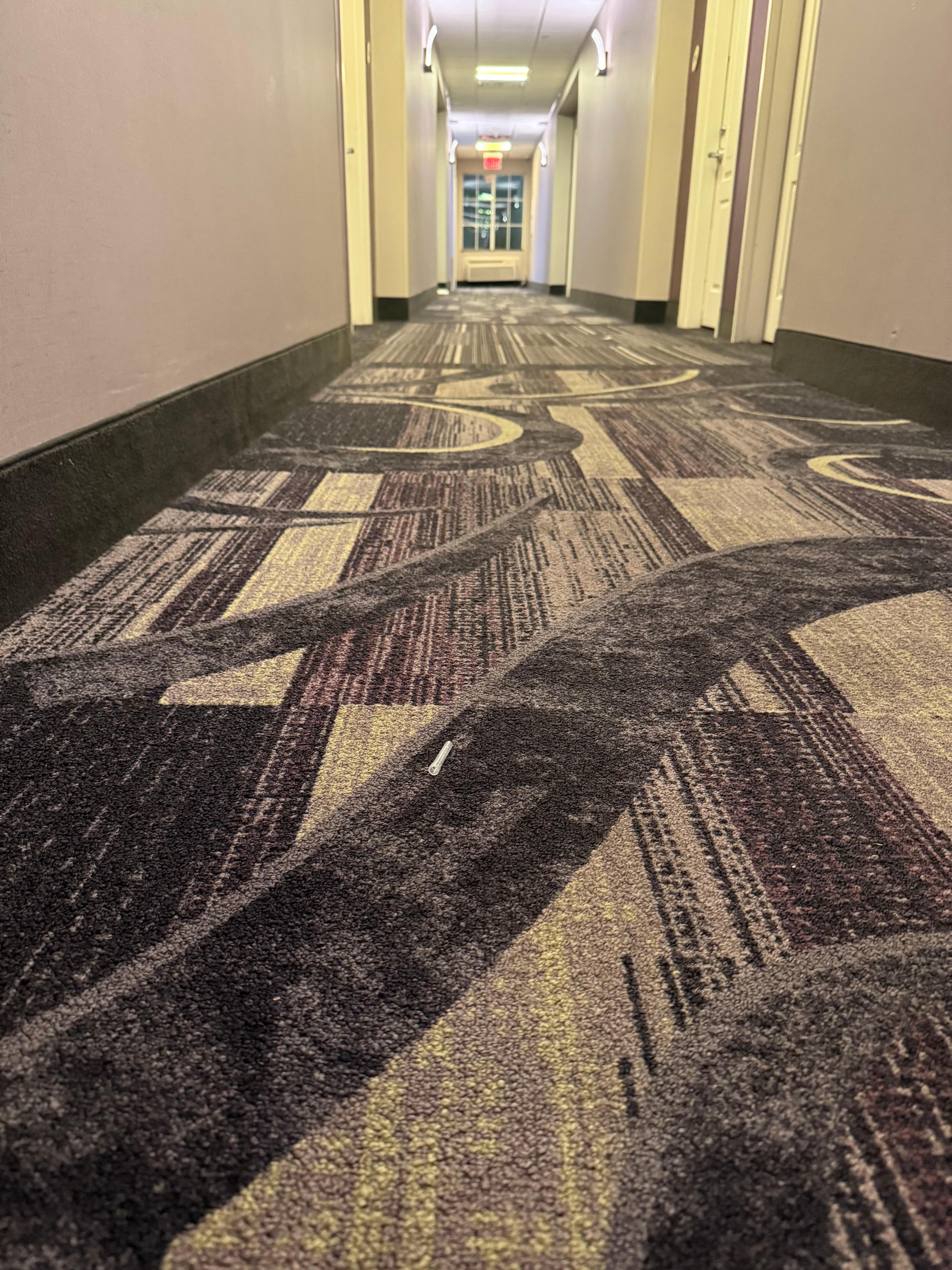 Where needle cap was located in hallway. 