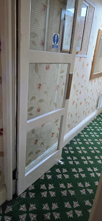 Fire doors propped open with a door wedge