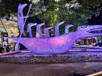 Located in front of the mall by the hotel.