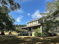 A real-life Green Gables! The most incredible front porch for watching hummingbirds on the porch swing!