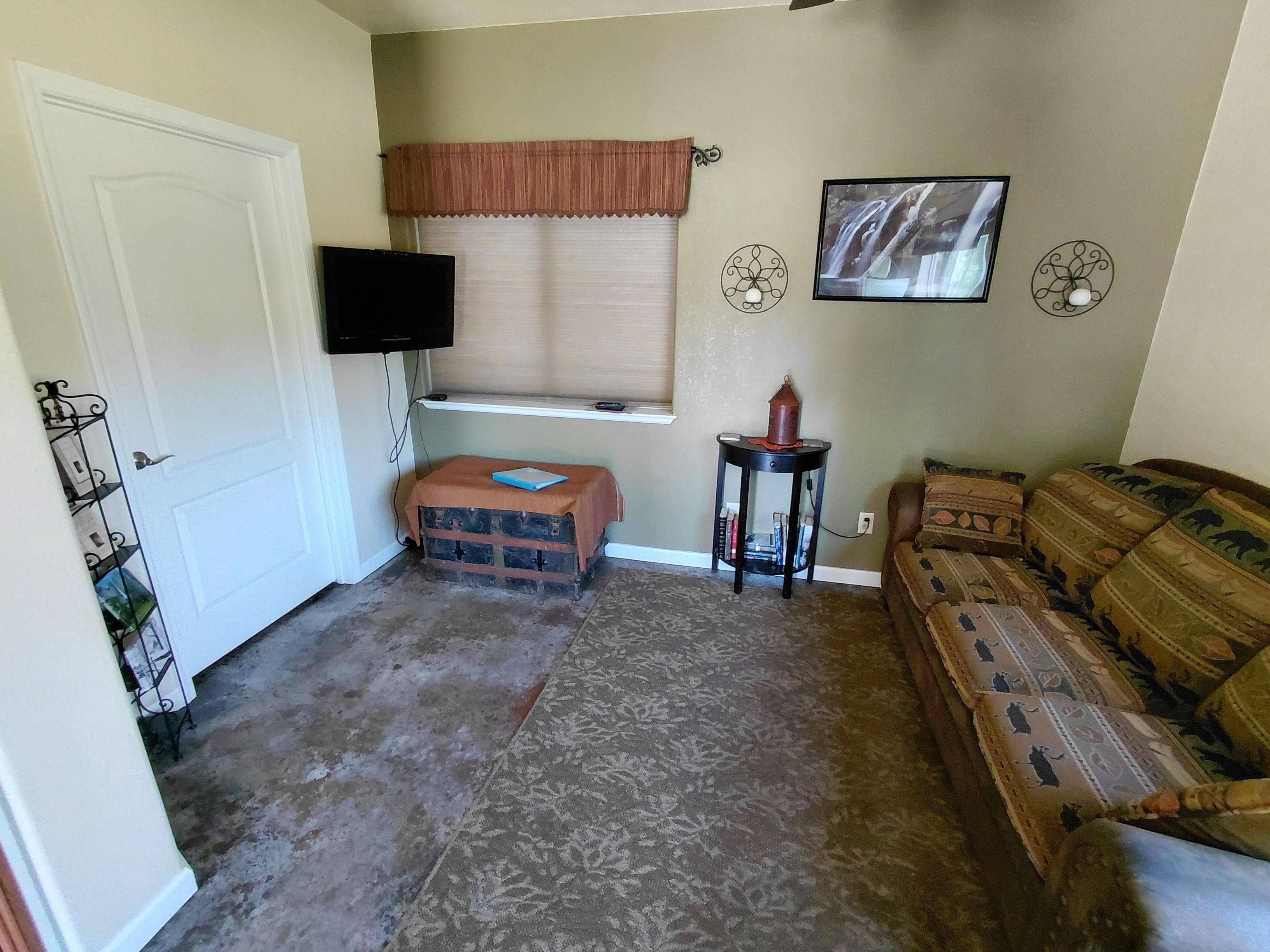 Spacious living area with dining table overlooking backyard and beyond.