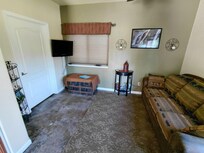 Spacious living area with dining table overlooking backyard and beyond.