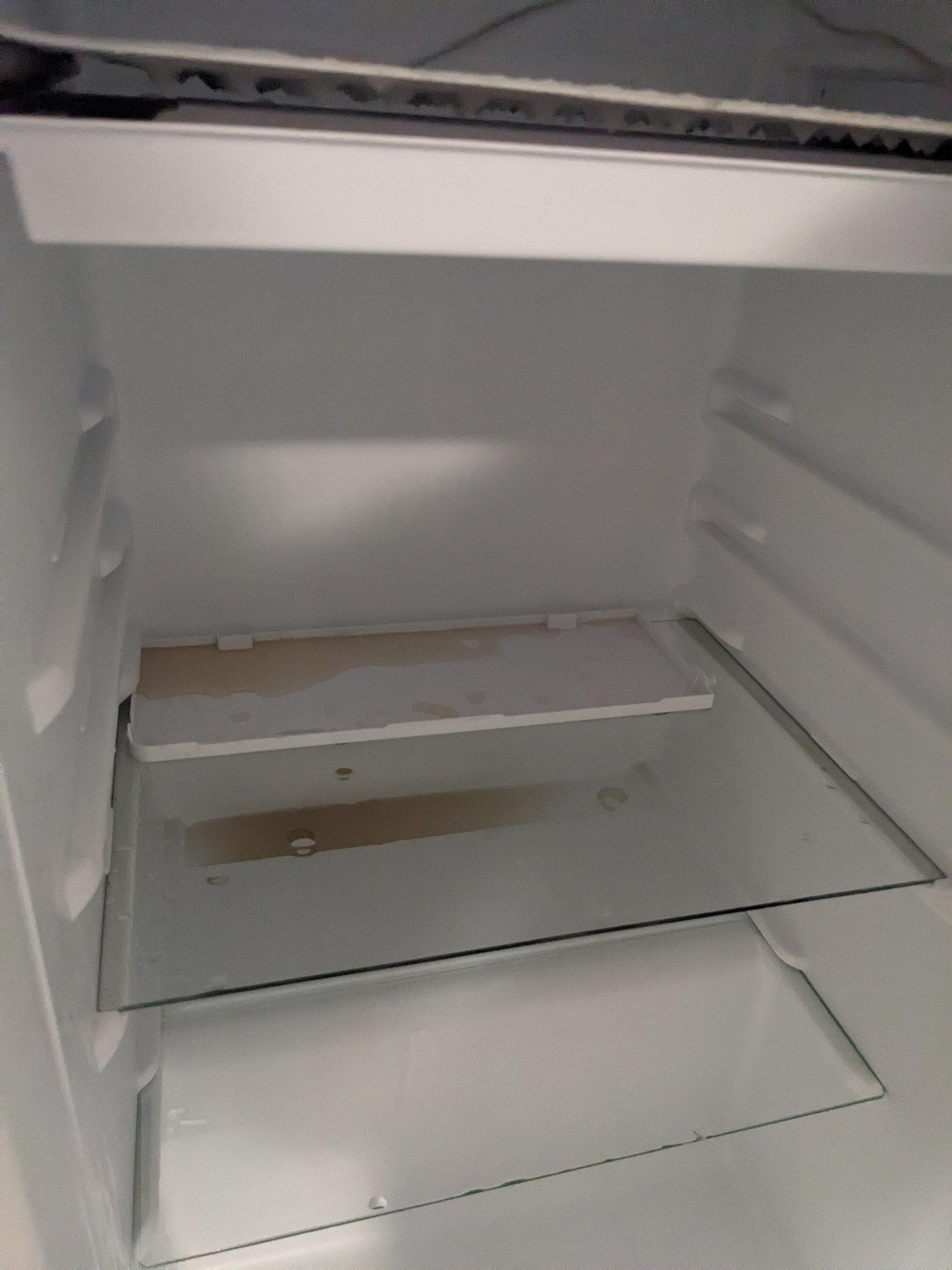 Broken and dirty mini fridge. 