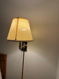 Wall lamp next to headboard