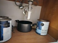 Bathroom with open paint cans.