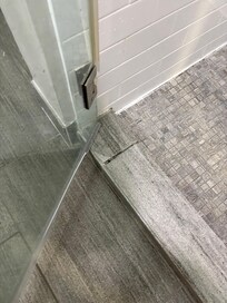 Door doesn’t shut. Uneven tile