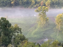The morning fog over the lake from the sun porch window.
