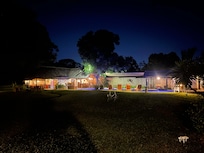 Pool and dining/bar area at night