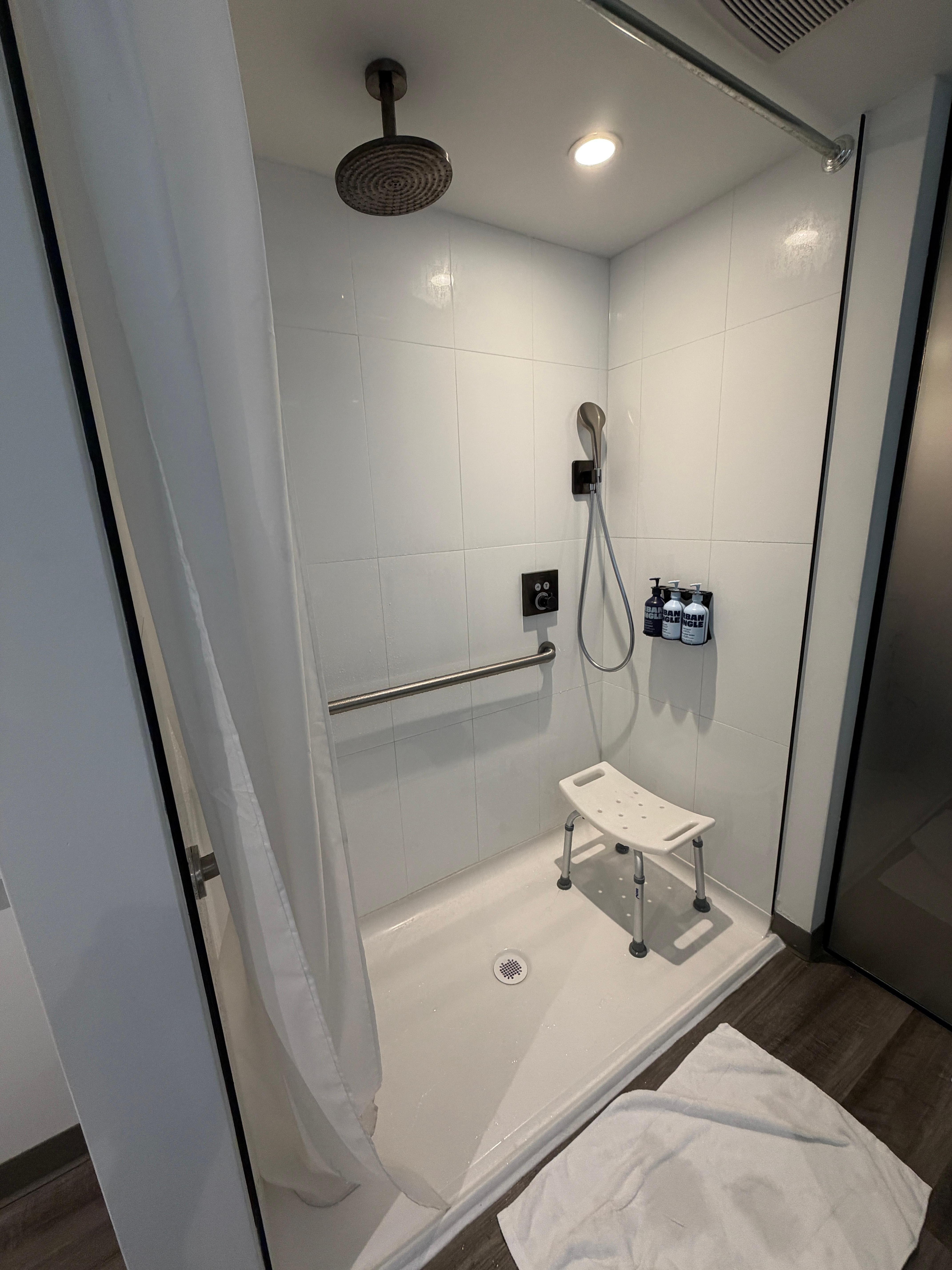 Not a fancy shower with tile and glass door you would expect in a VIP suite... You get the acrylic floor and the nylon curtain... and the little plastic bench...