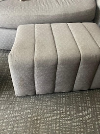 The ottoman. We had to use a blanket to cover the couch so we could sit.