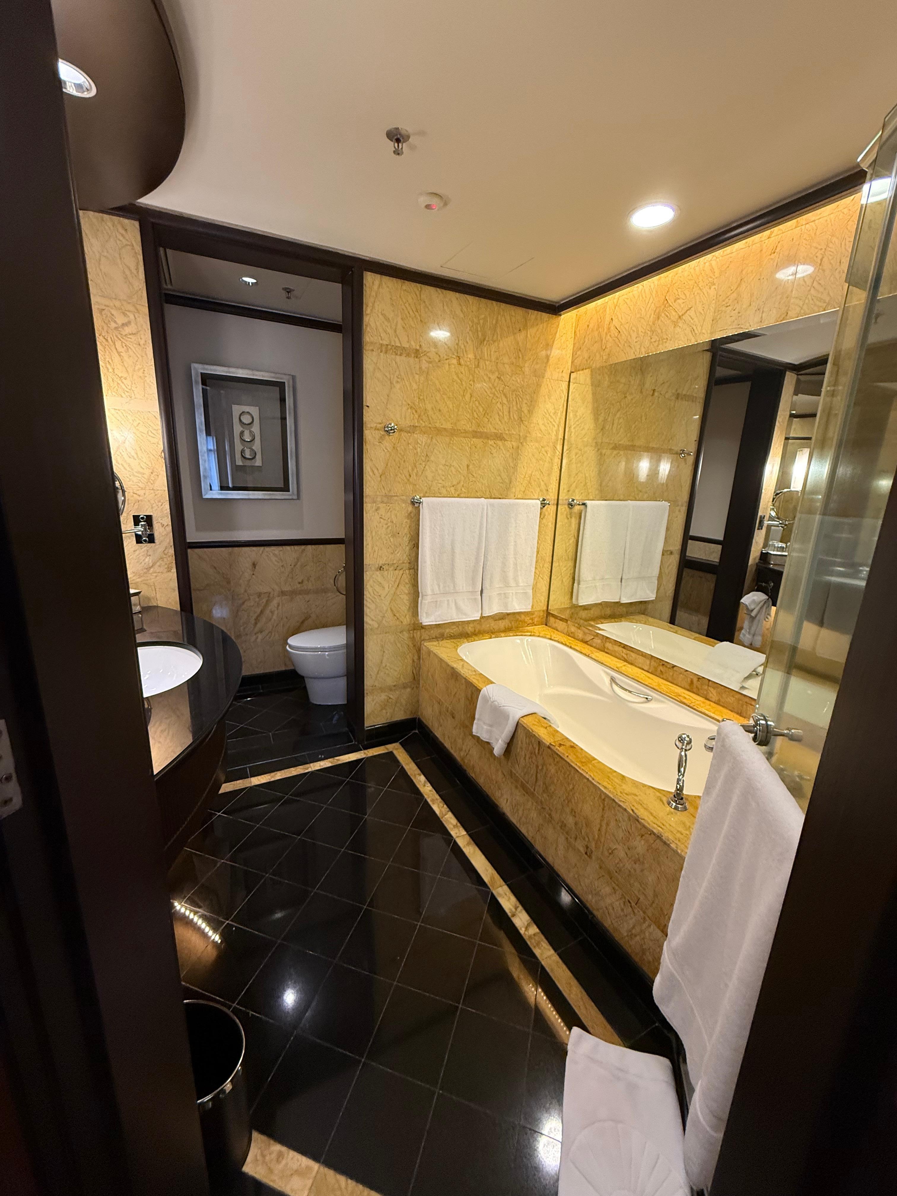 Bathroom including separate shower and tub and toilet area