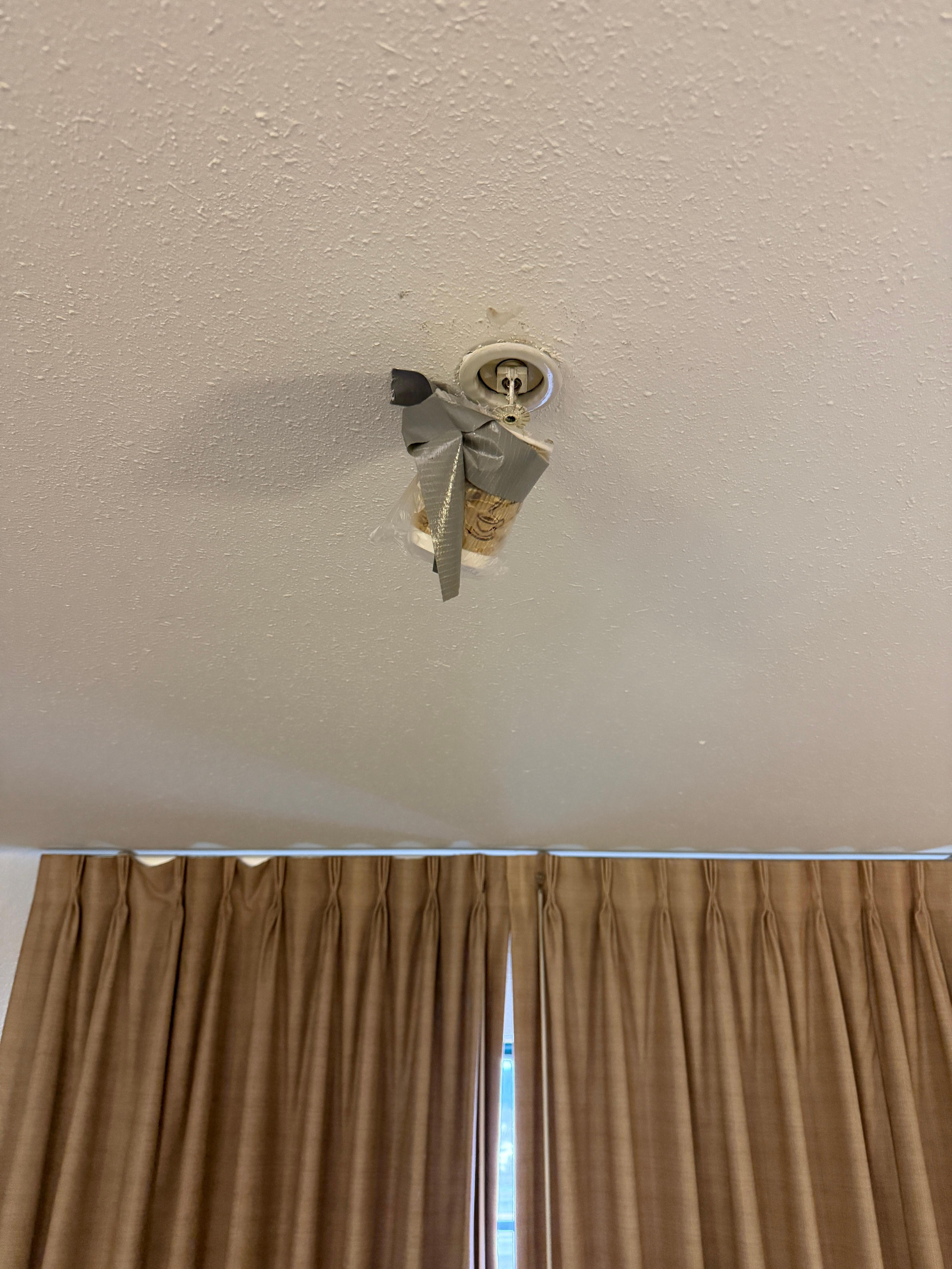 Fire sprinkler covered by plastic & tape