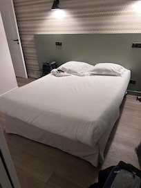 This was the bedroom on arrival. Nothing like the photos on line in the description. No pretty towel arrangements. No bed throws. Clean sheets. Uncomfortable pillows