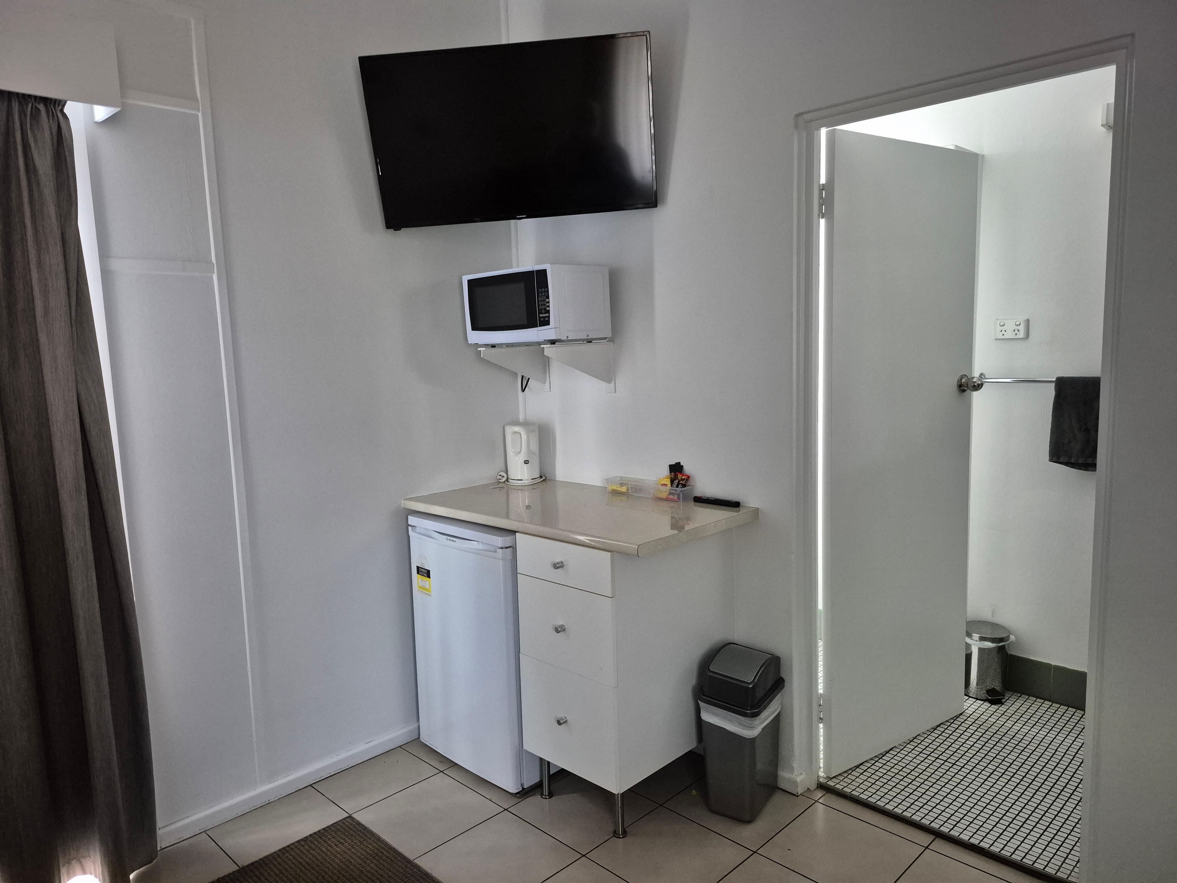 Kitchen area with microwave and utensils 