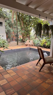 Amenity of the hotel with lots of chairs and nice waterfall sound