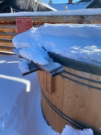 Empty hot tub; two boards with nails stacked on it