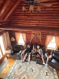 Livingroom with large flat screen TV and 4 recliners.