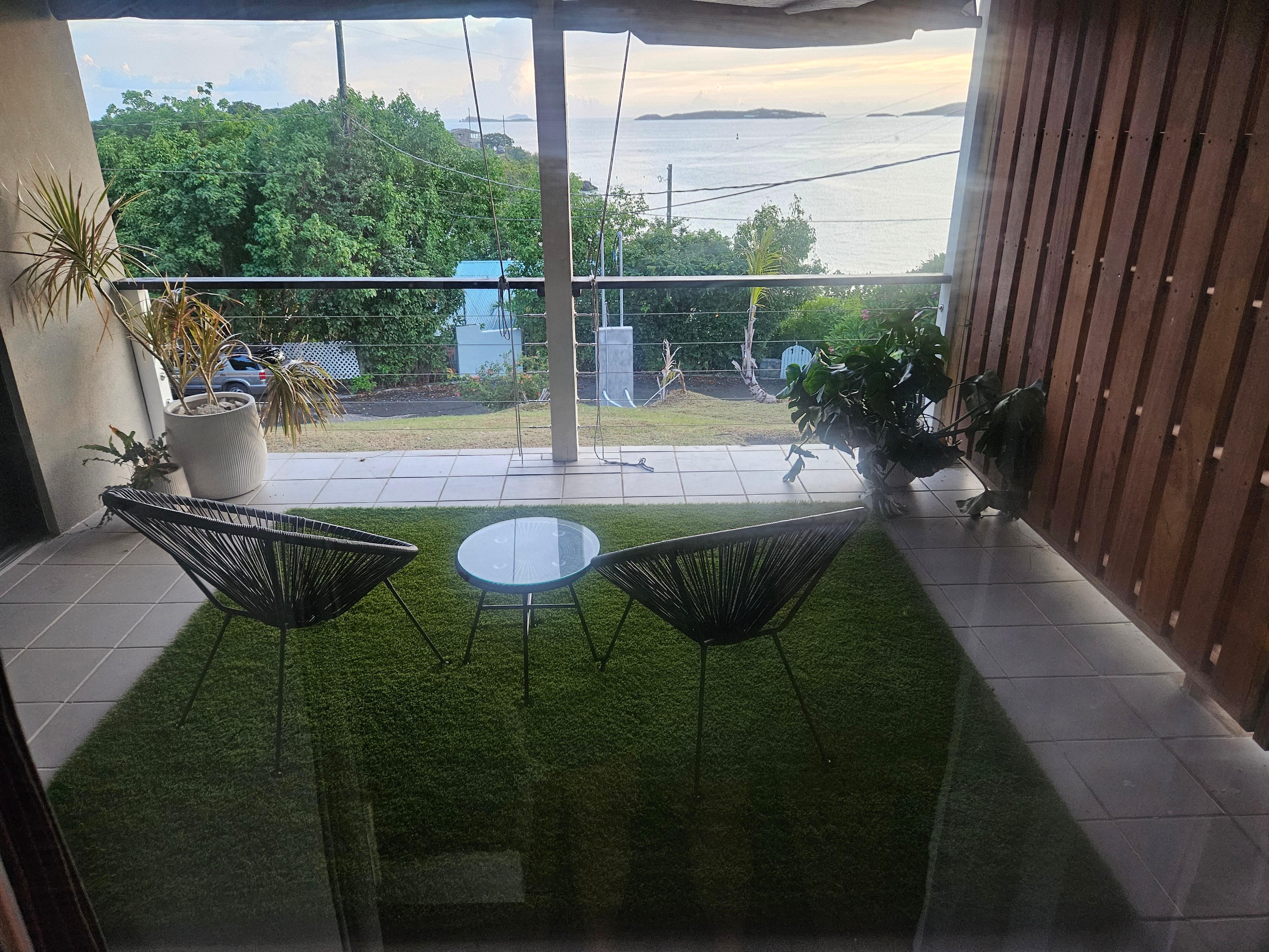Patio from Hanson Room, wooden wall has a locking gate that has to be unlocked from both sides for access by the neighboring room, in the event they are travel partners. 