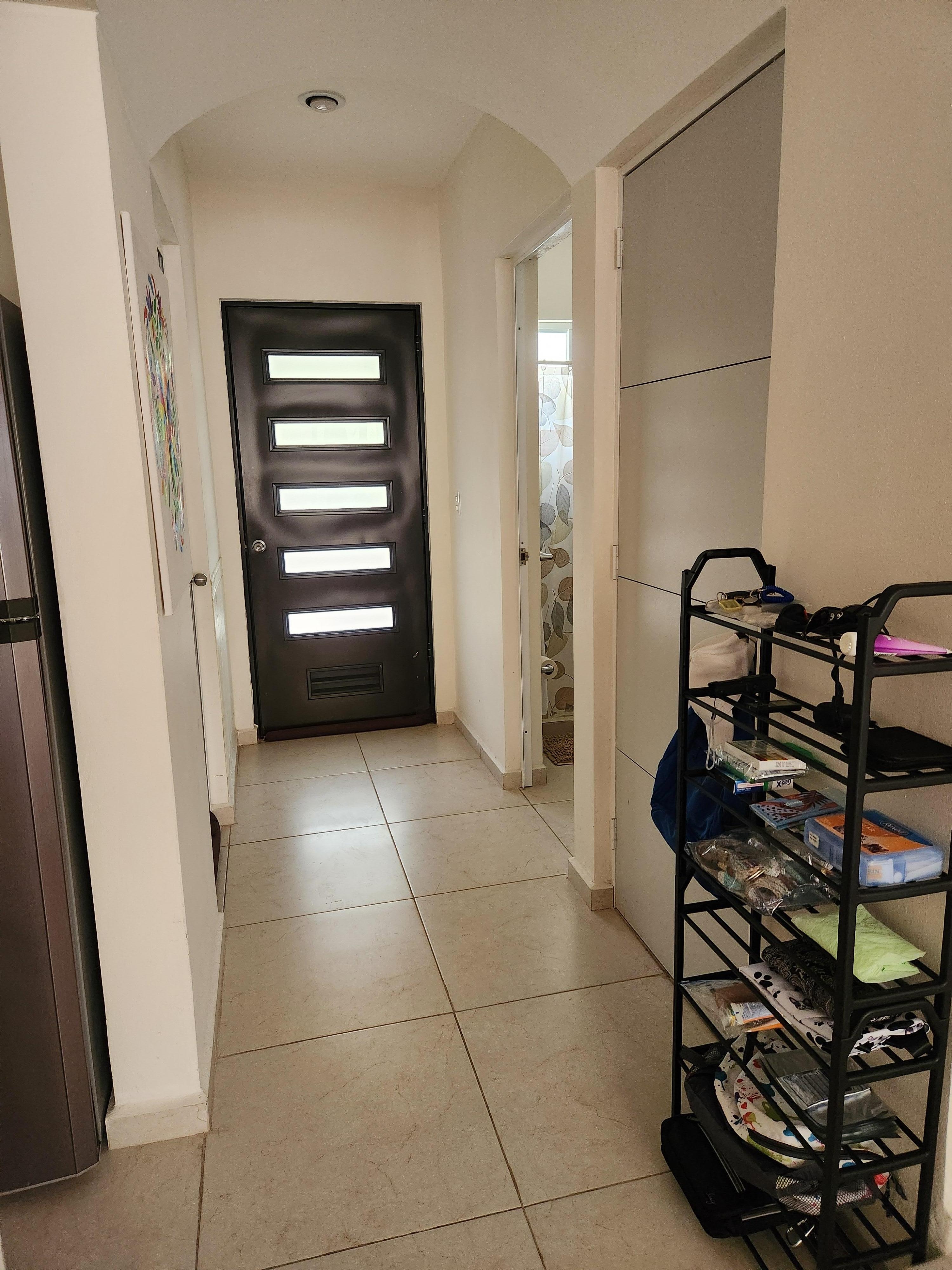 Hall, showing distance to front door. There is a 
bath, and bedroom across from it.