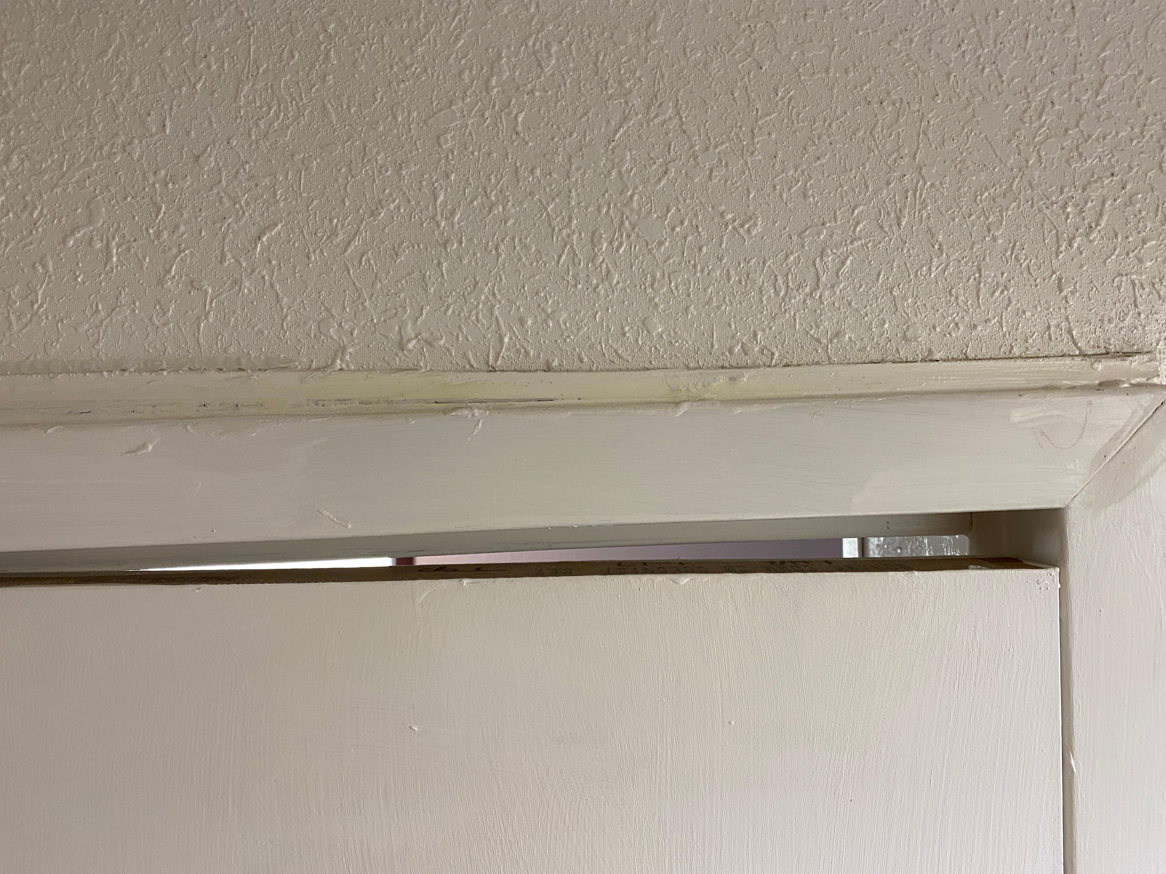 main room door gap at the top lets air noise and light in from the hallway.