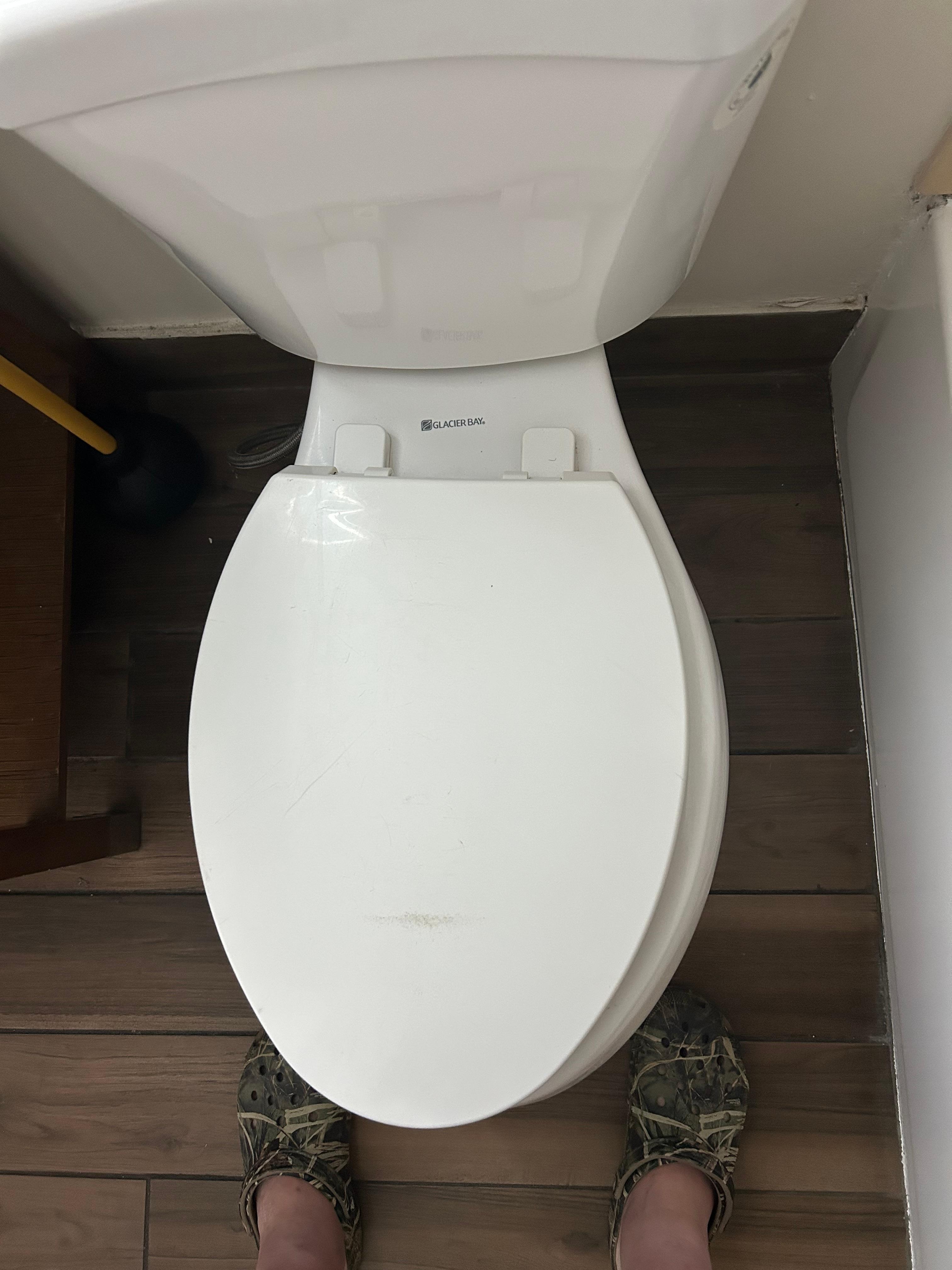 Toilet seat rocks side to side