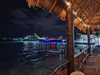 the patio at night, view of the ferry to Isla Mujeres
