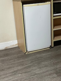 Water damage in the refrigerator cabinet and wall behind