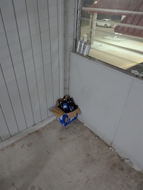 Empty beer bottle laying around and not cleaned up after two days