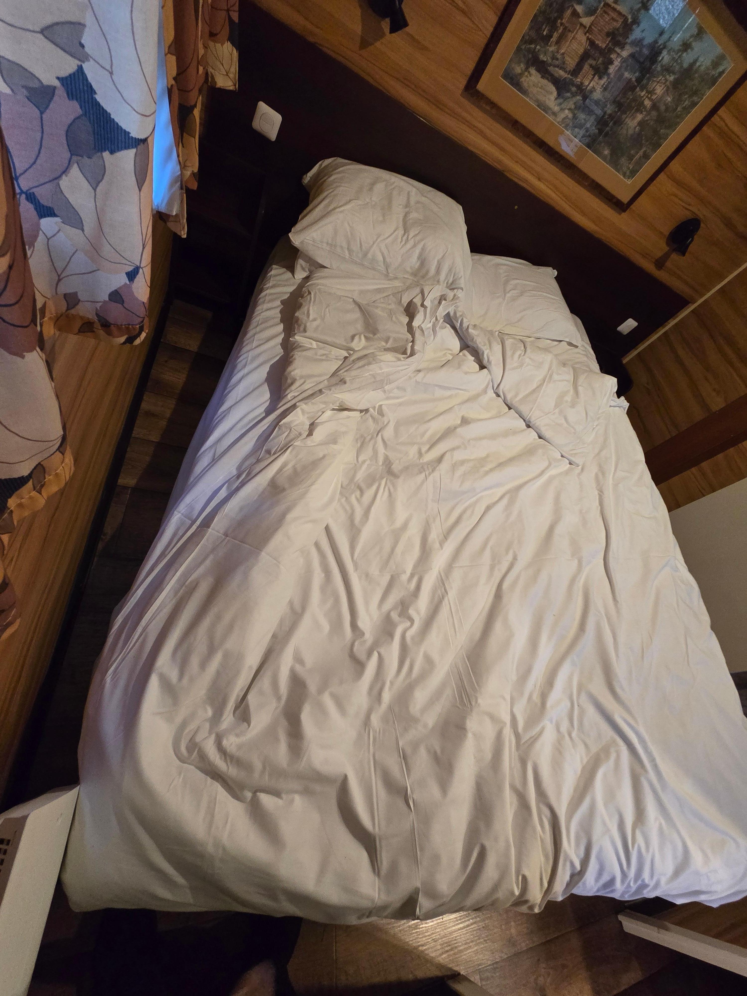 The broken bed, half on the floor. How does this even happen???