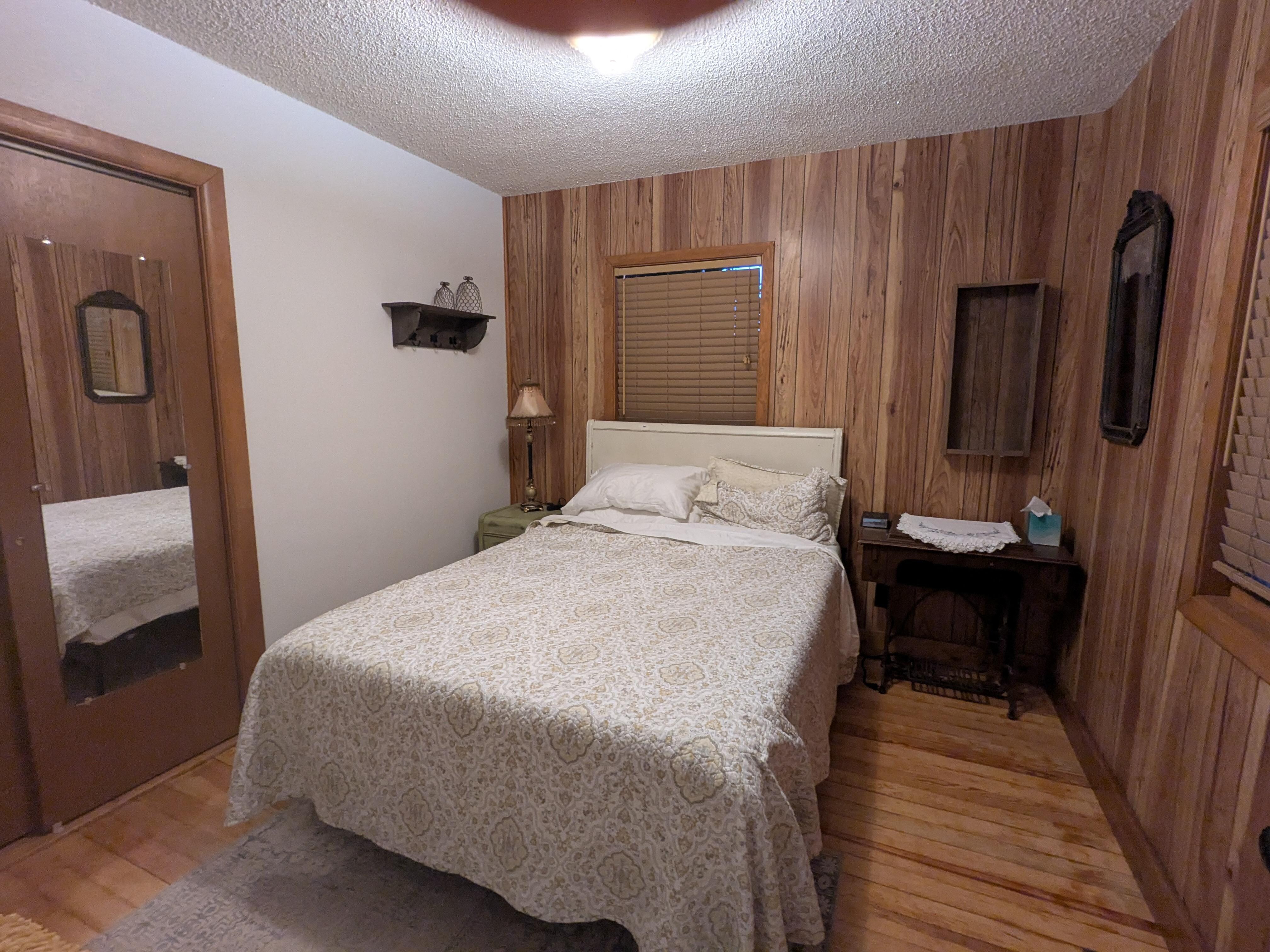 One of the downstairs bedrooms with an old-fashioned sewing machine repurposed for a nightstand.