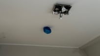 Smoke detector wrapped with a bag and dangling