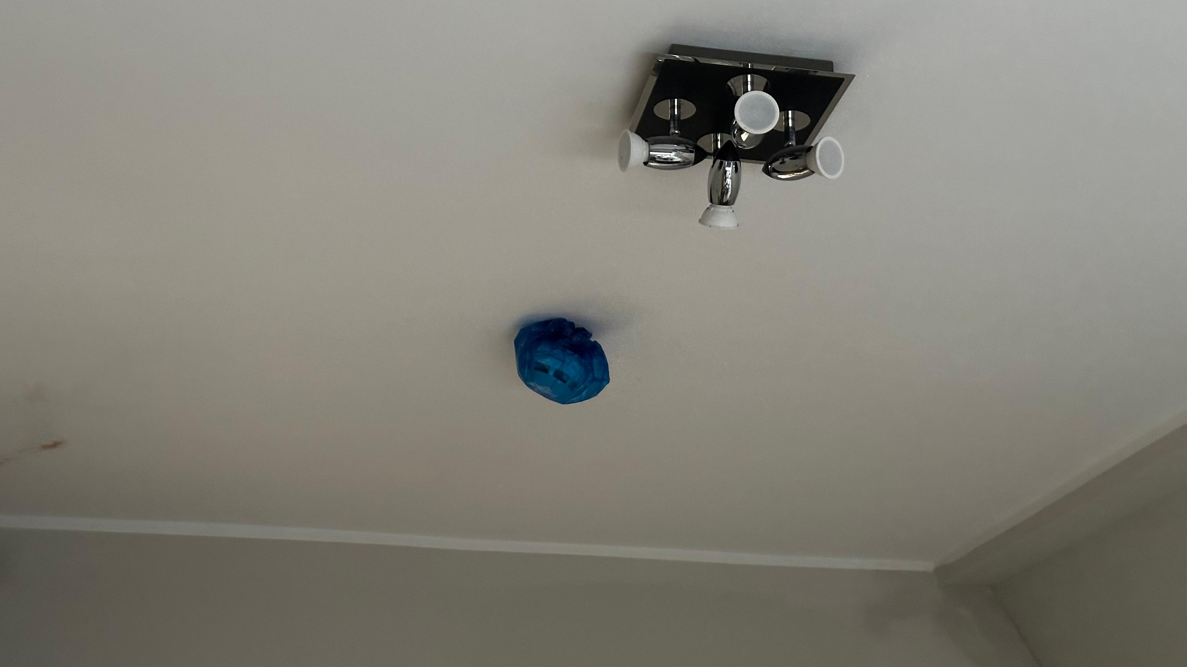 Smoke detector wrapped with a bag and dangling 