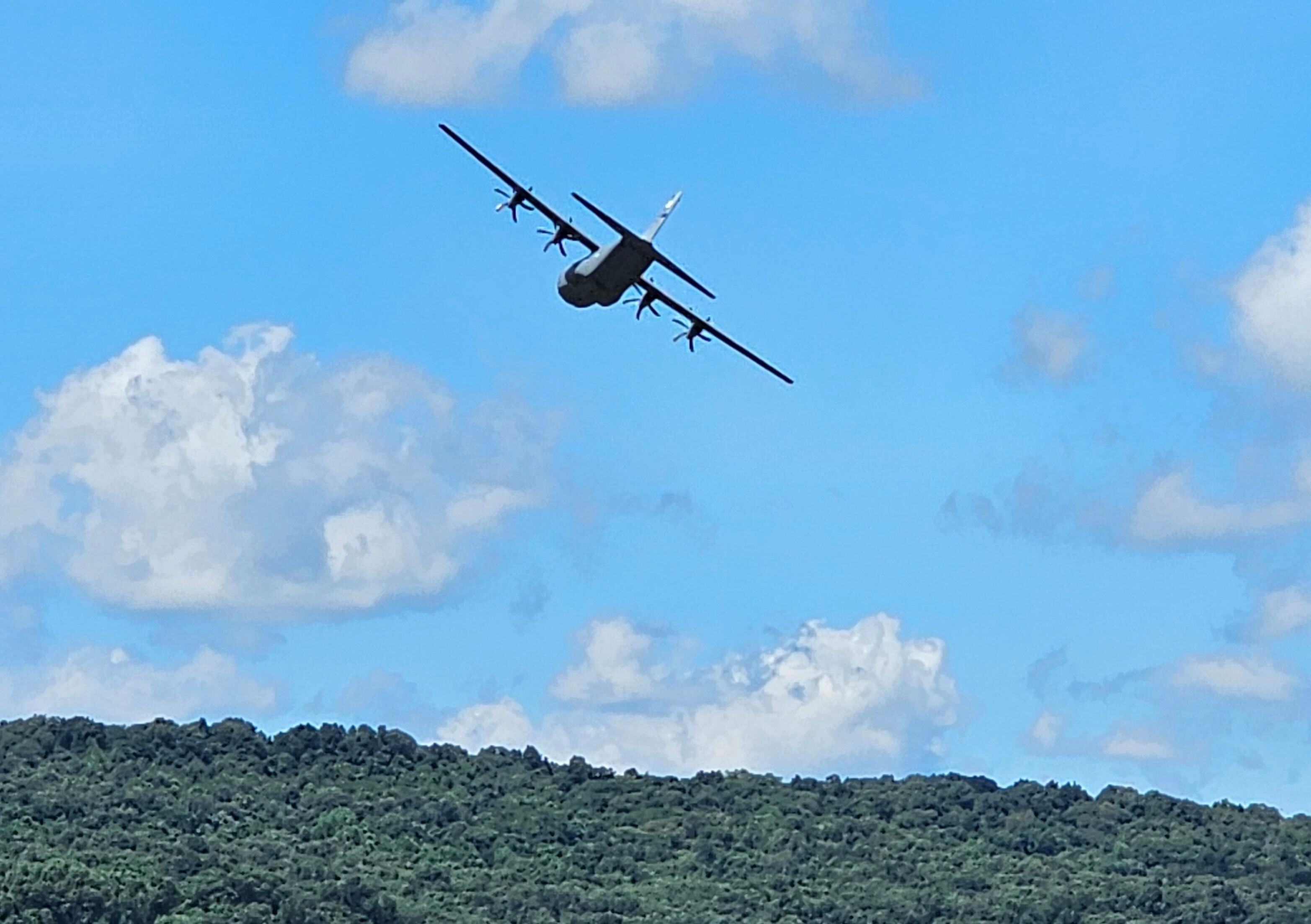 Military plane following the river