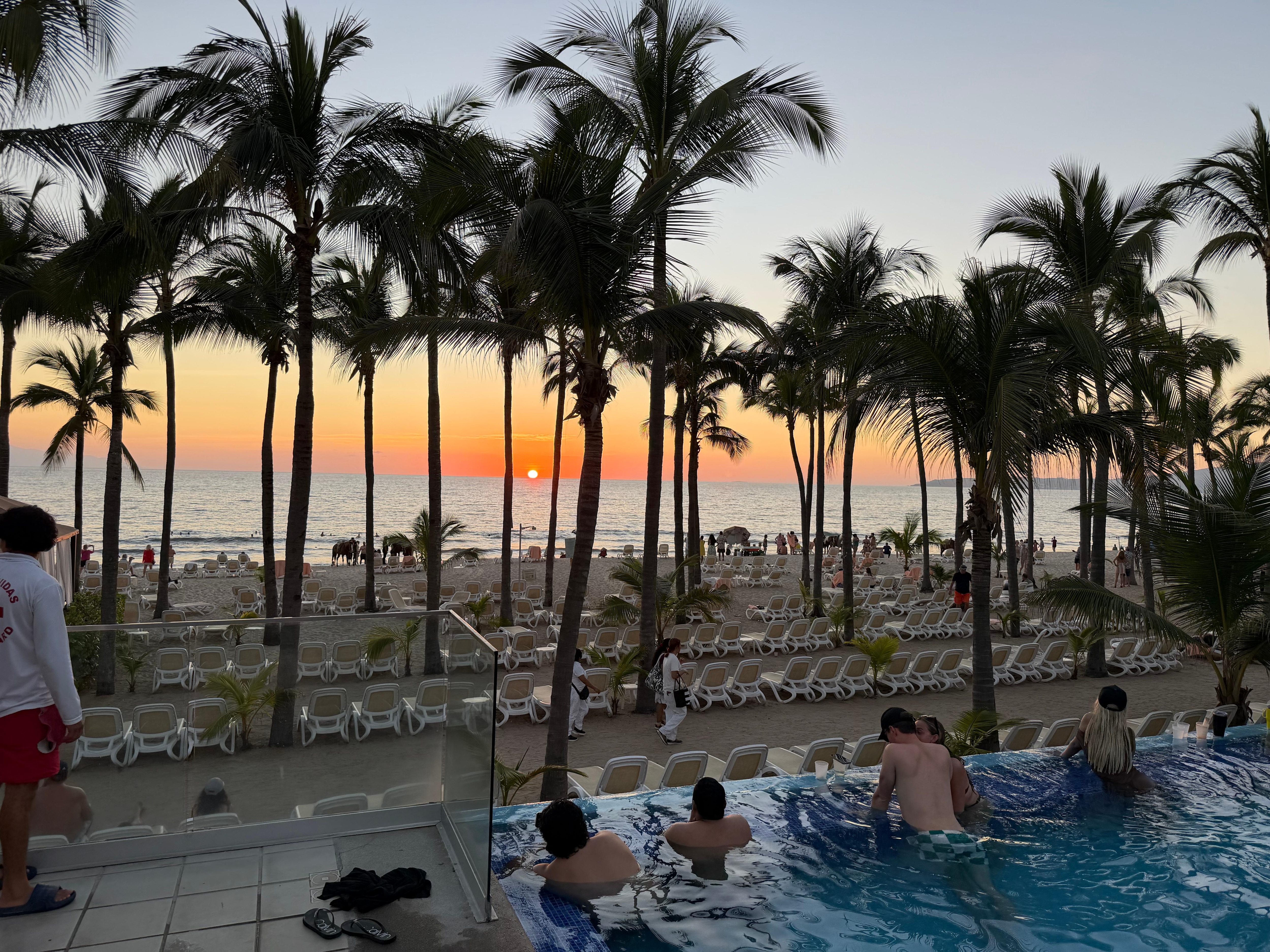 View of the sunset by the beach and adult pool