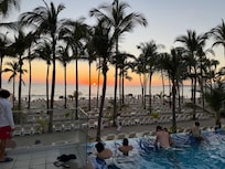 View of the sunset by the beach and adult pool