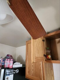 The upper cabinets, the doors all open so that the ceiling fan, if in operation, would hit the doors. The design of the kitchen is poor, you have to open doors the wrong way they should, the door of the fridge opens the wrong way.