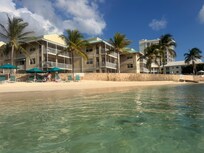 View from water, looking at beach. Pool/resort is behind rock wall