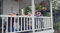 The guys watching the water activity from the back porch.