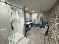 The bathroom has an amazing shower and the walls in the rooms add so much charm to the place