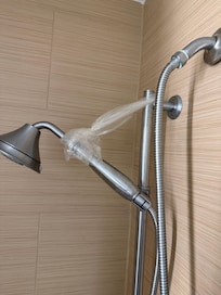 Plastic bag holding up the shower head