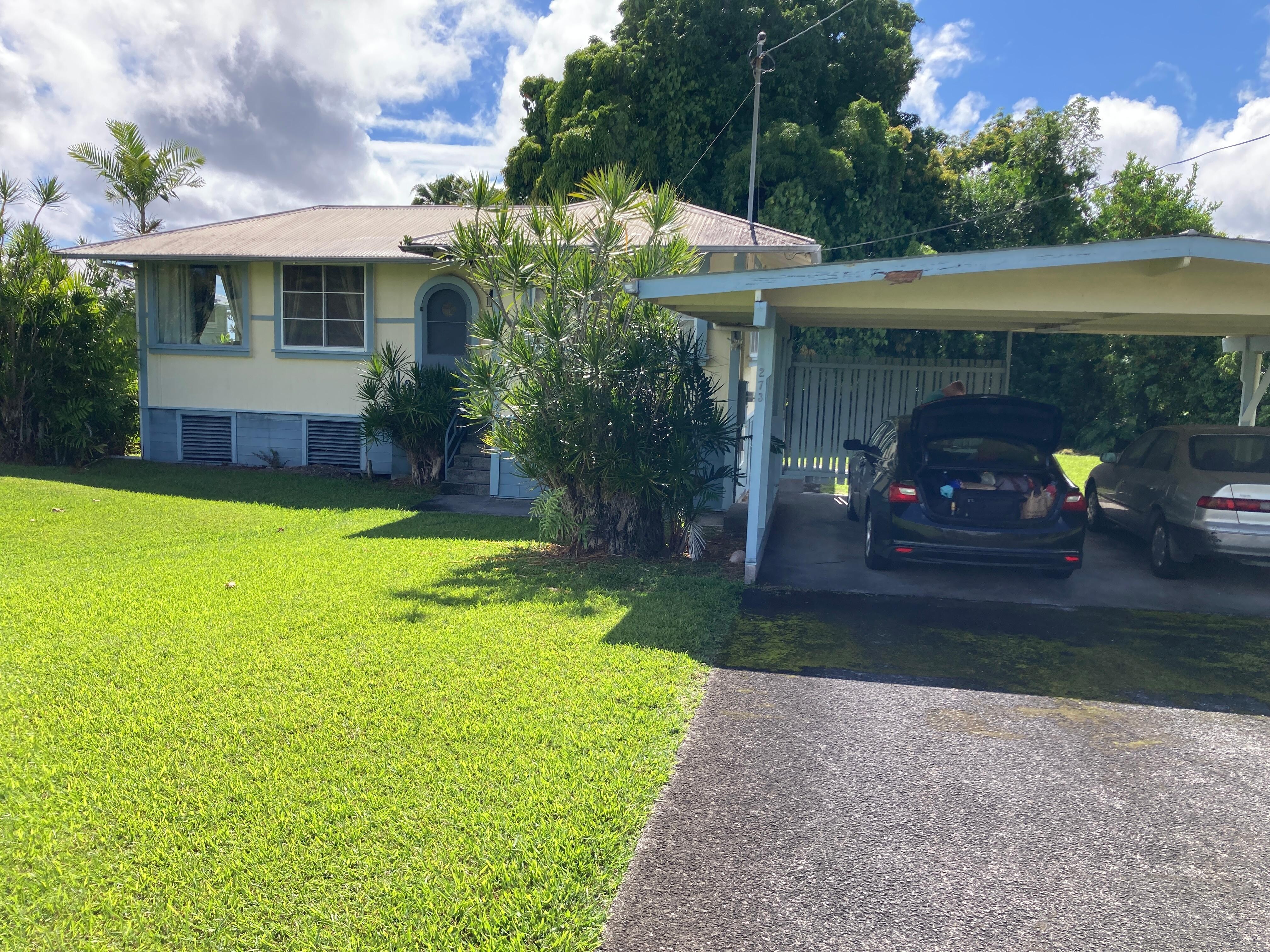 Front of house and carport.
