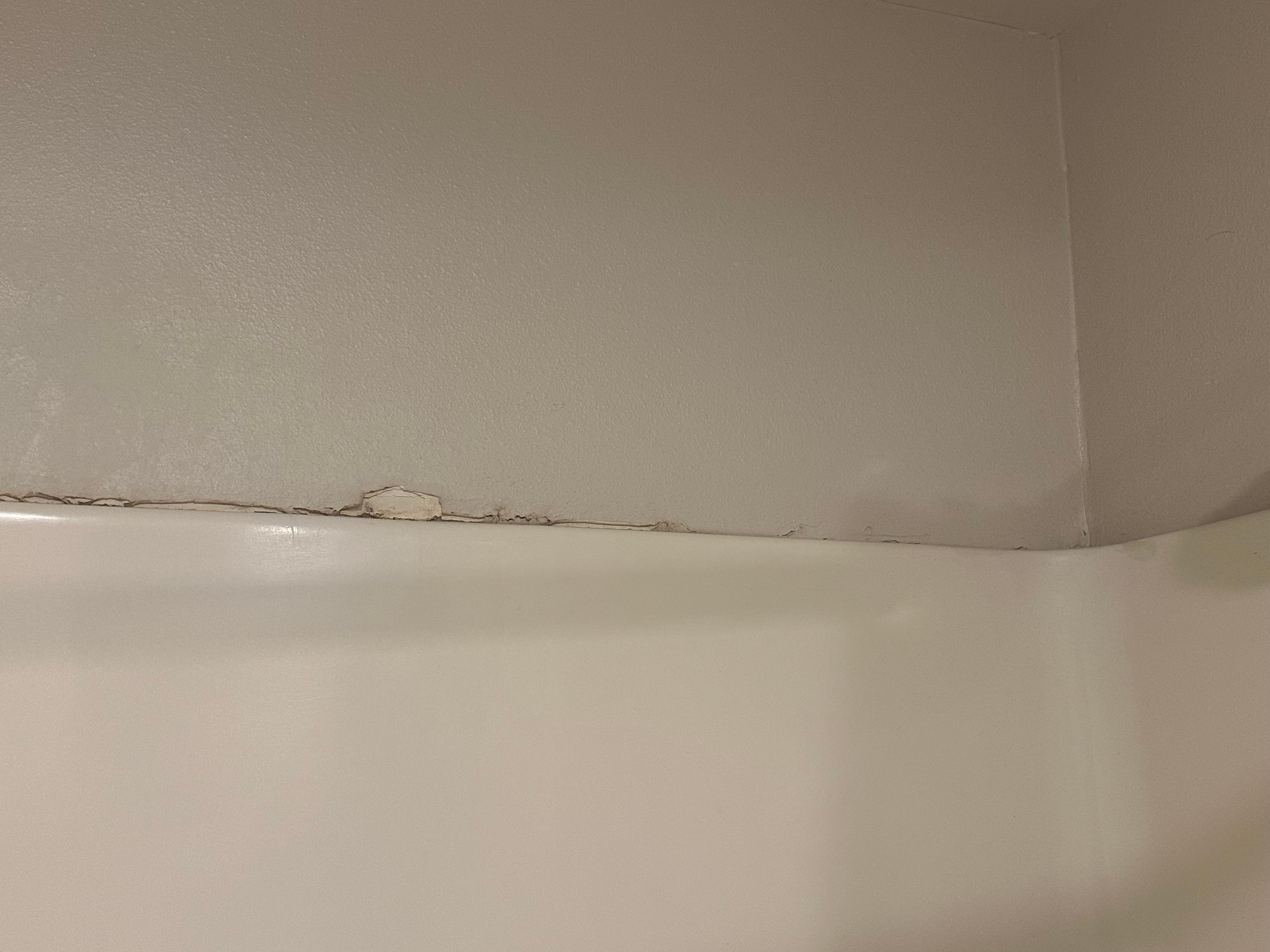 Shower wall with knuckle imprints