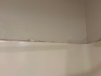 Shower wall with knuckle imprints