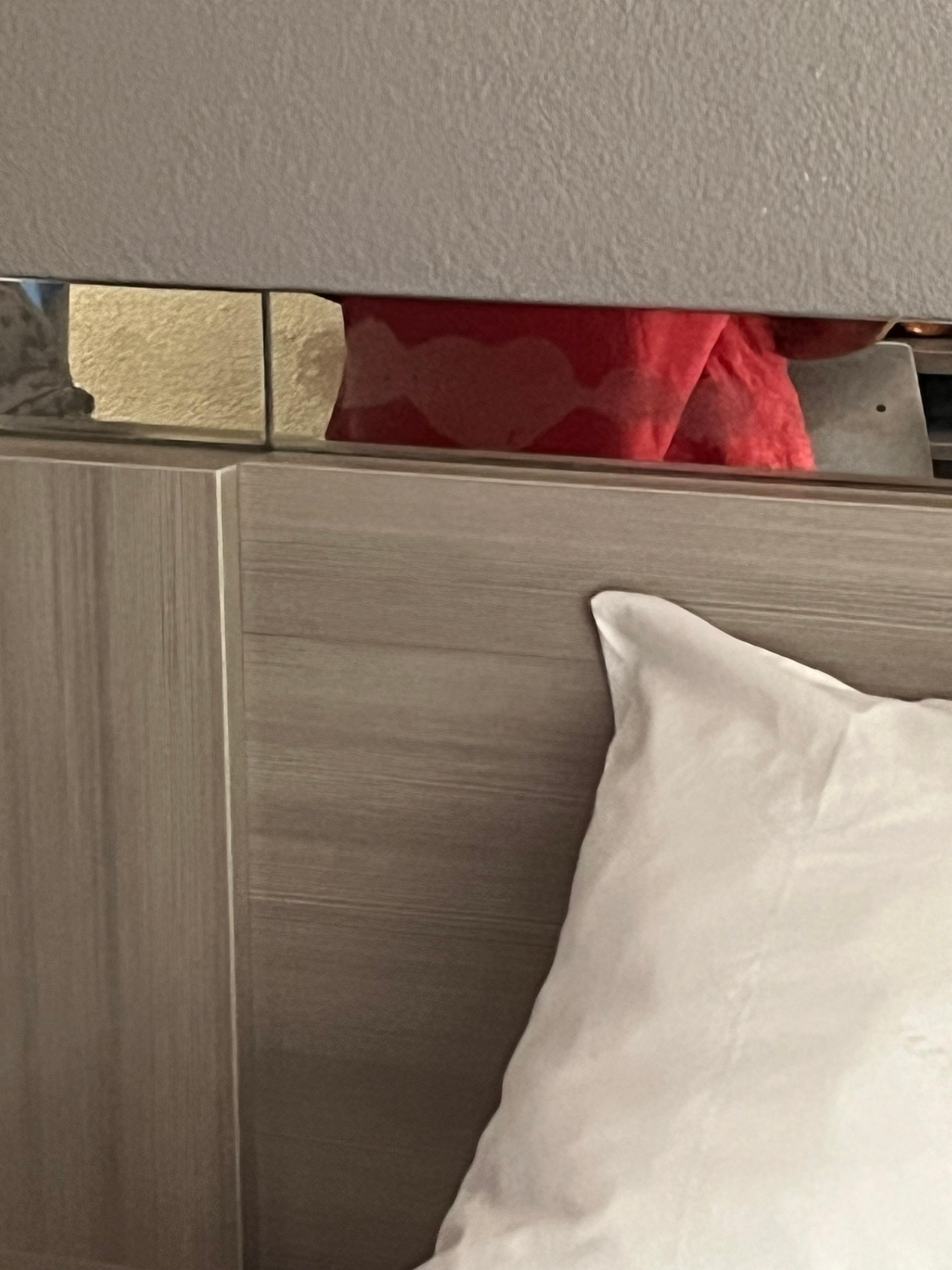 There were hand and foot prints on the mirror border on the headboard 