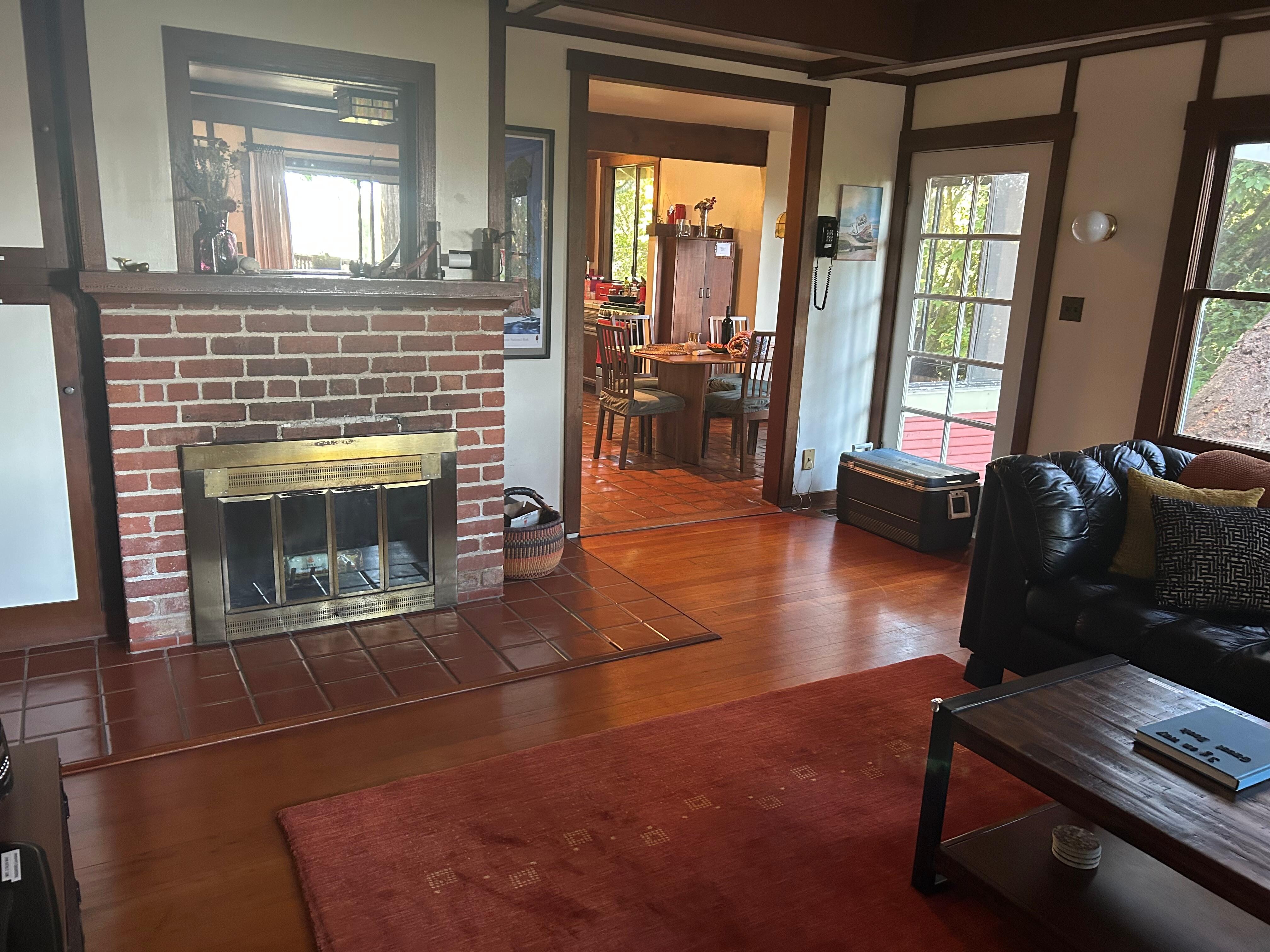 Living room and fireplace looking towards dining room room and kitchen